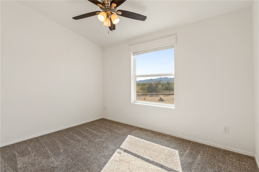 3534 Eloy Road Golden Valley, AZ 86413 - Photo 21 of 58 Bedroom featuring carpet floors and ceiling fan