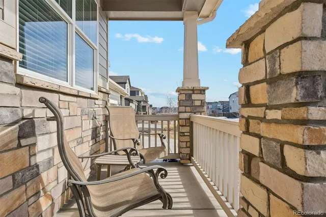 a view of balcony with two chairs and a table