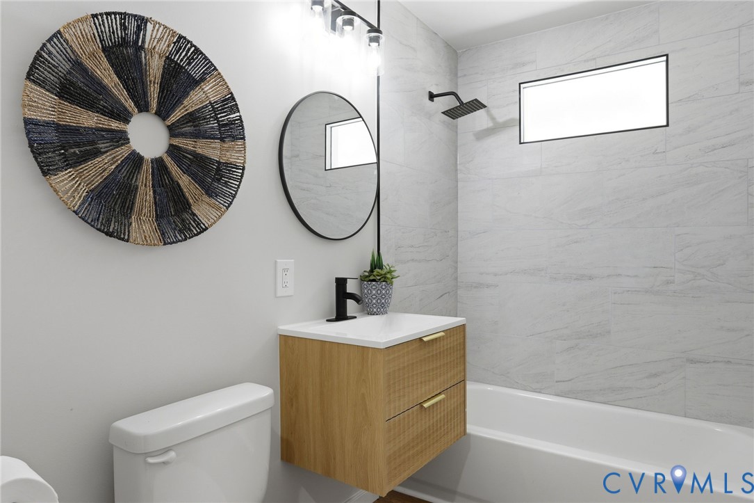 3490 Willow Brook Road Bumpass, VA 23024 - Photo 20 of 29 a bathroom with a sink a mirror a toilet and a shower