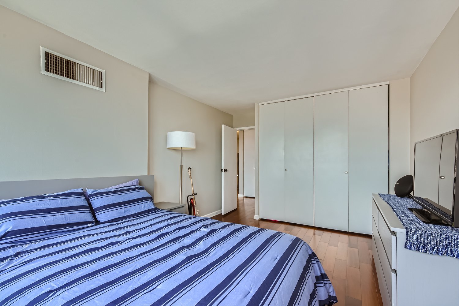 1636 North Wells Street, Unit 1505 Chicago, IL 60614 - Photo 11 of 21 a bedroom with a bed and a flat tv screen on a dresser