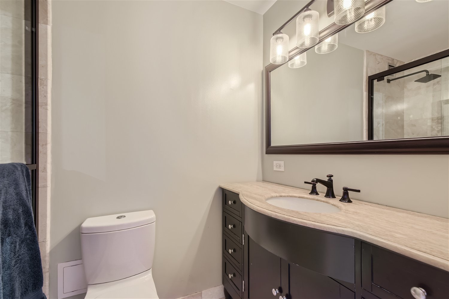 1636 North Wells Street, Unit 1505 Chicago, IL 60614 - Photo 12 of 21 a bathroom with a sink a toilet and a mirror