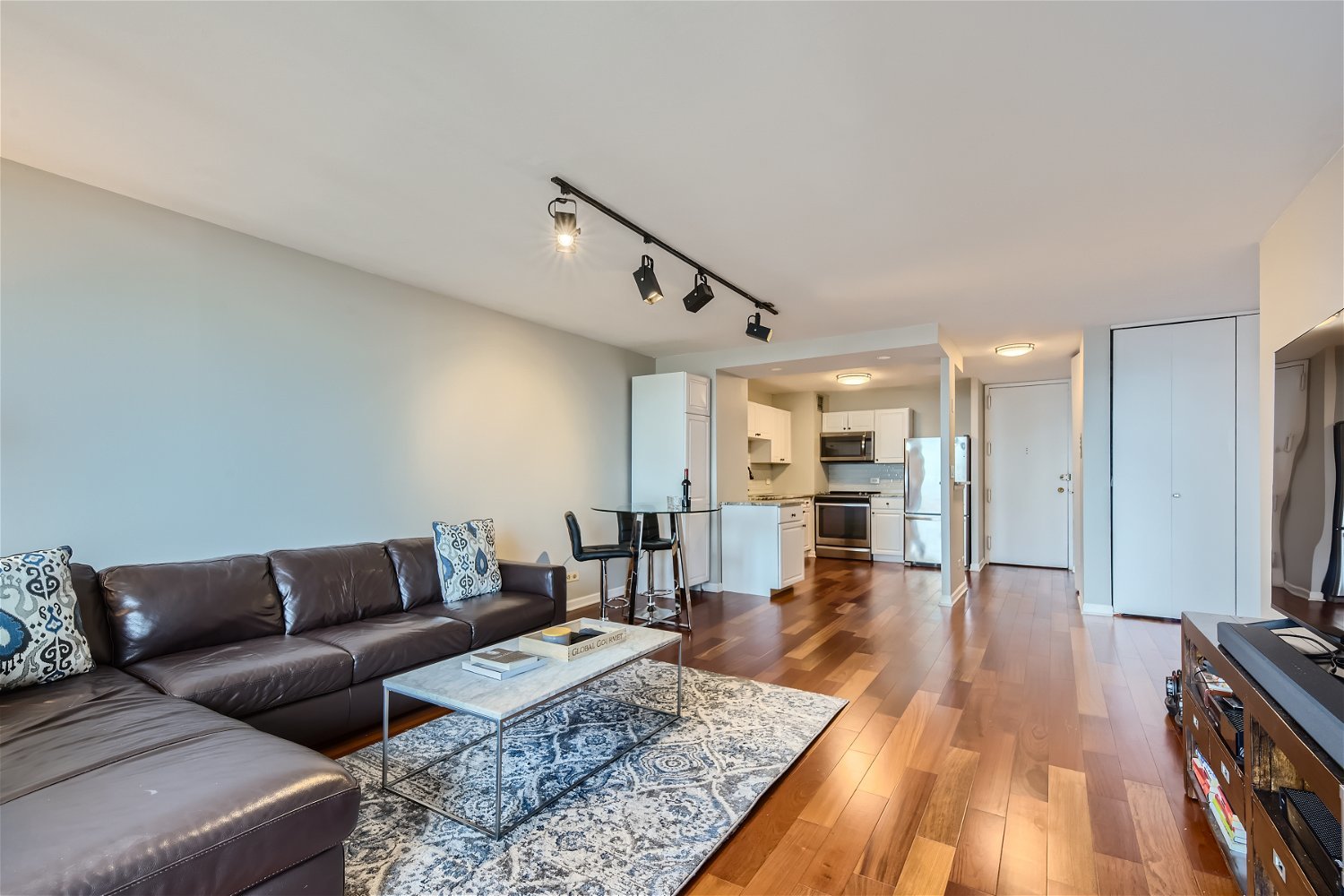 1636 North Wells Street, Unit 1505 Chicago, IL 60614 - Photo 3 of 21 a living room with furniture and a wooden floor