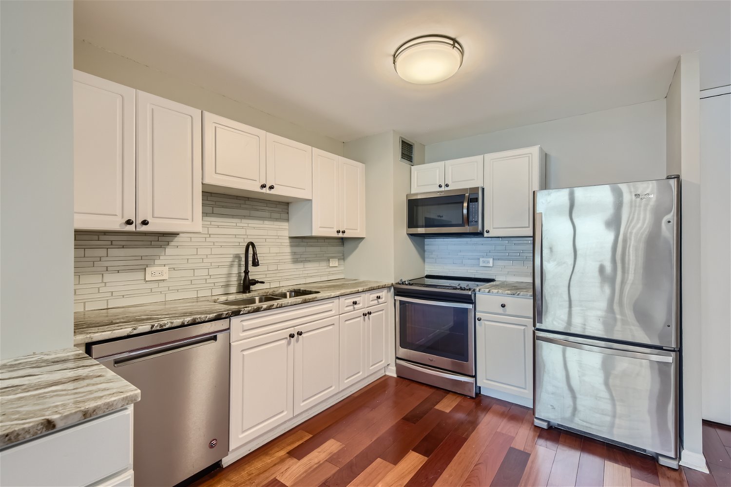 1636 North Wells Street, Unit 1505 Chicago, IL 60614 - Photo 5 of 21 a kitchen with cabinets stainless steel appliances and wooden floor