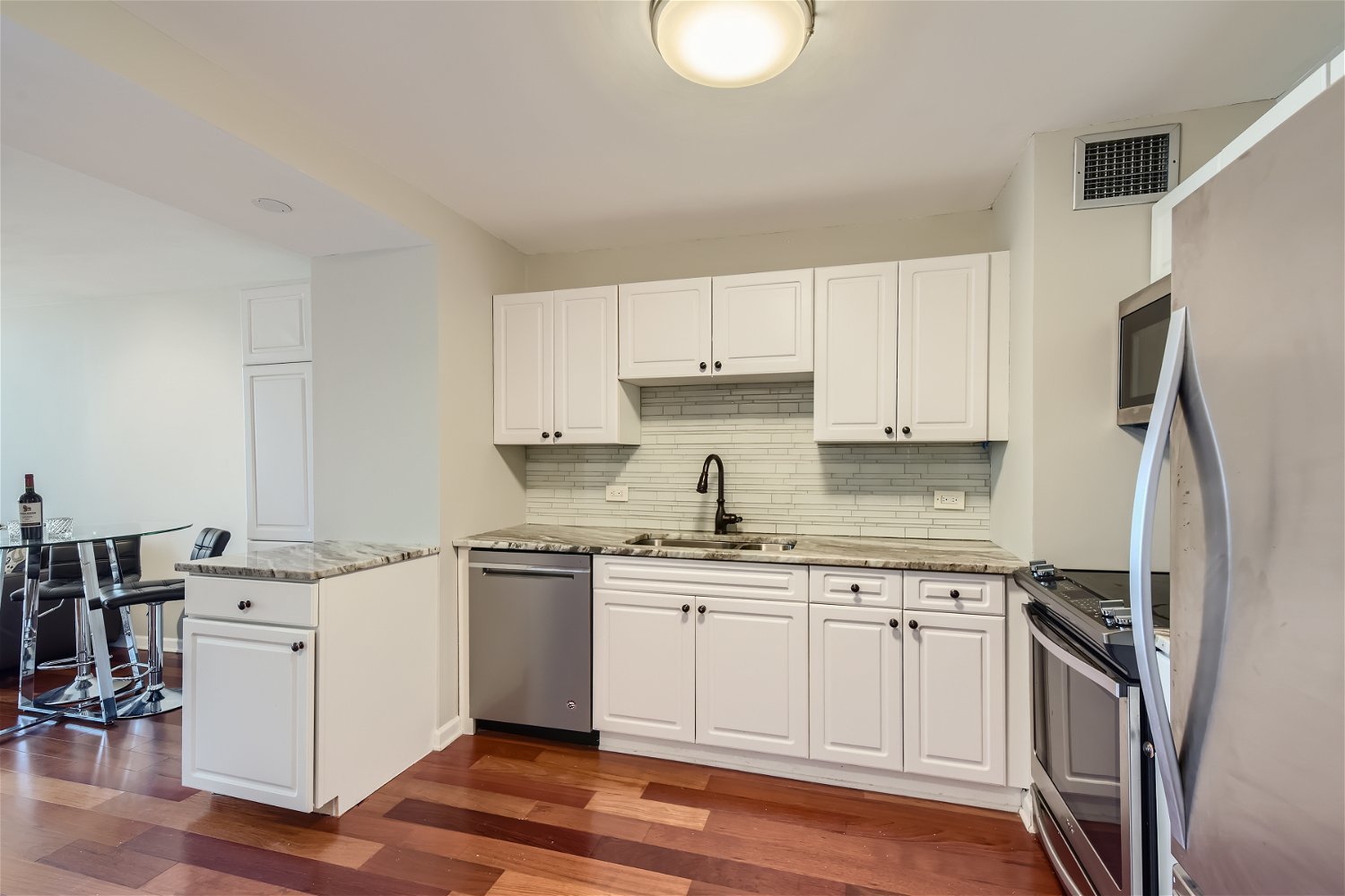 1636 North Wells Street, Unit 1505 Chicago, IL 60614 - Photo 6 of 21 a kitchen with stainless steel appliances granite countertop a sink stove and refrigerator