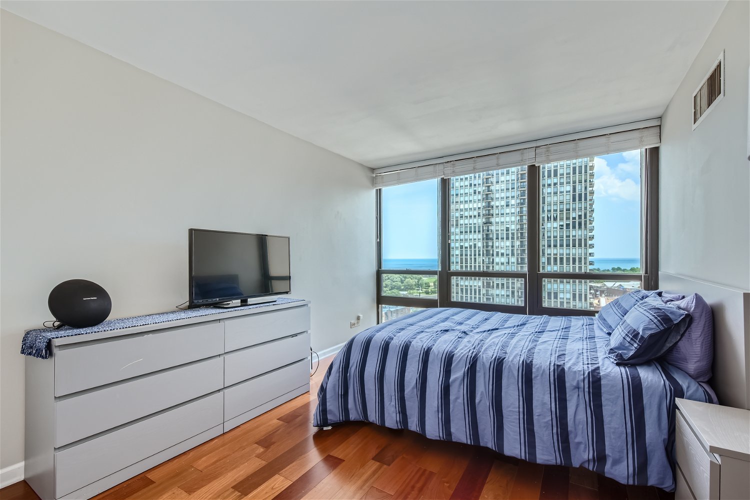 1636 North Wells Street, Unit 1505 Chicago, IL 60614 - Photo 9 of 21 a bedroom with a bed and a flat screen tv