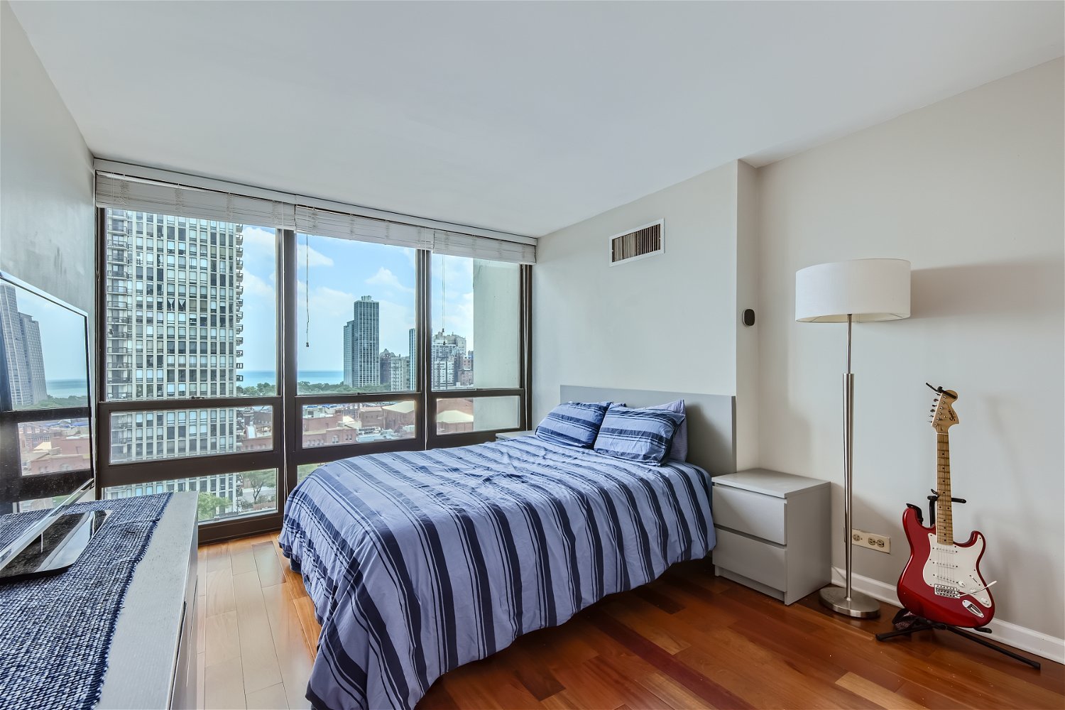 1636 North Wells Street, Unit 1505 Chicago, IL 60614 - Photo 10 of 21 a bedroom with a bed and wooden floor