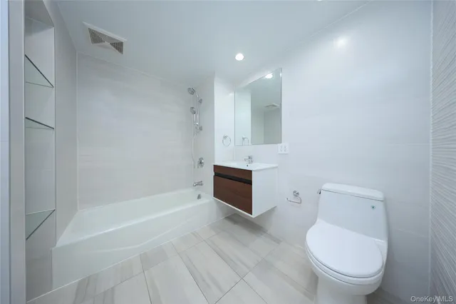 a bathroom with a toilet a sink and bathtub