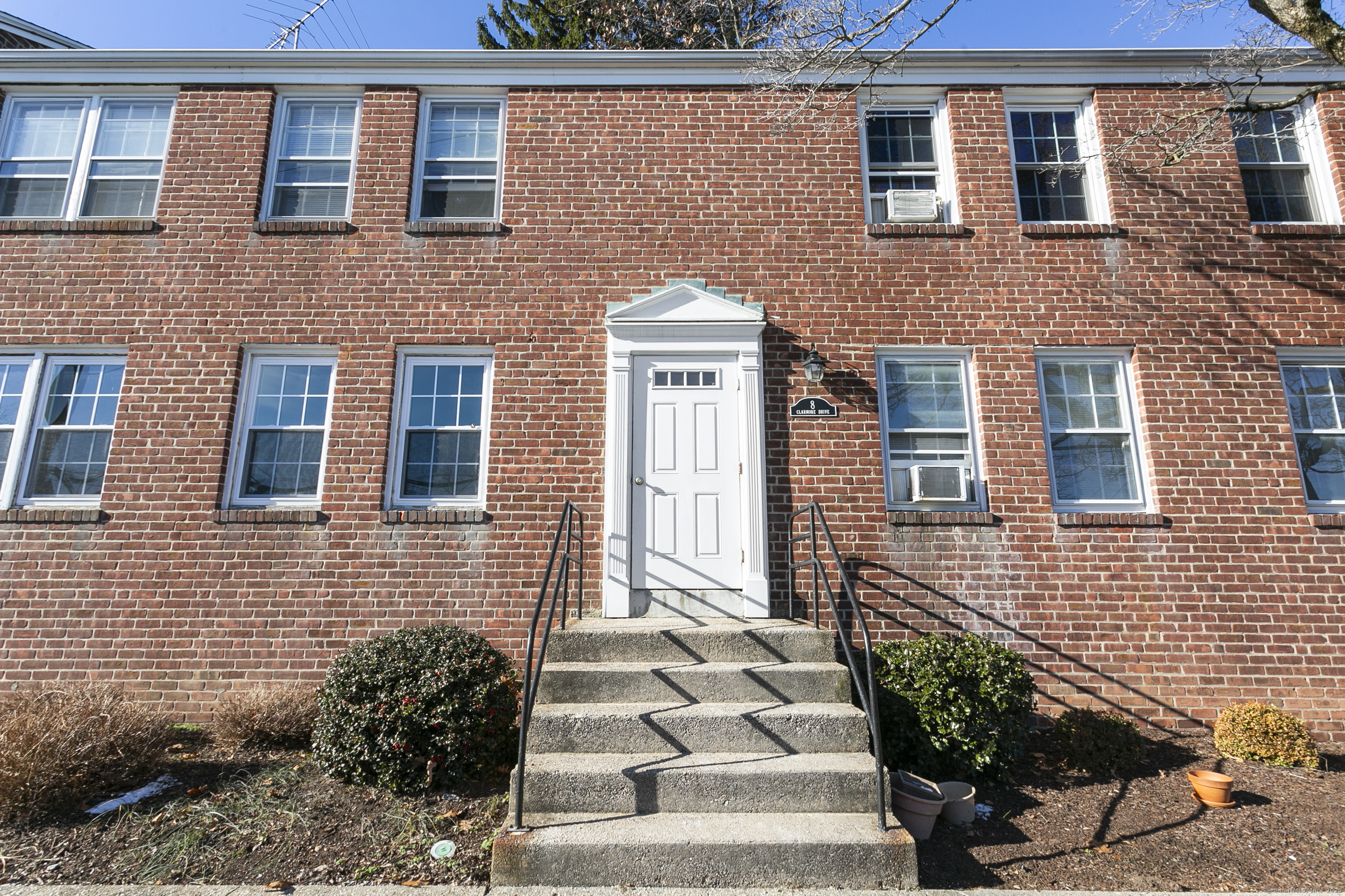 a front view of a house with a garden
