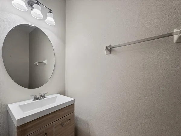 a bathroom with a sink vanity and a mirror