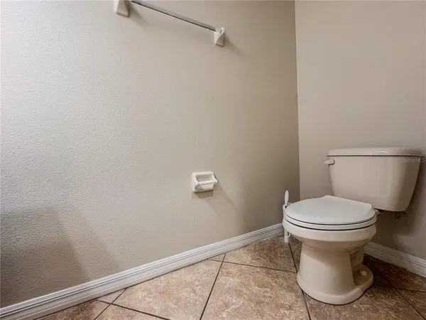 a white toilet sitting next to a shower
