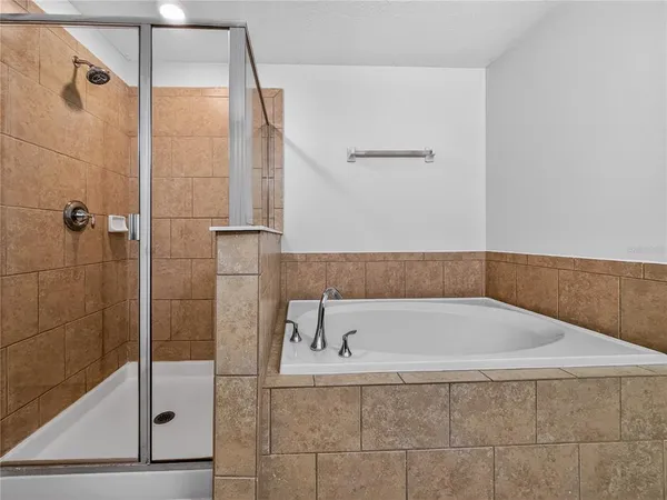 a bathroom with a tub and shower