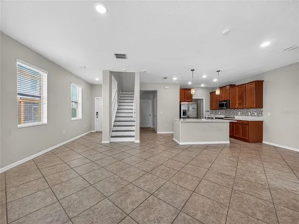 a view of kitchen with stainless steel appliances cabinets