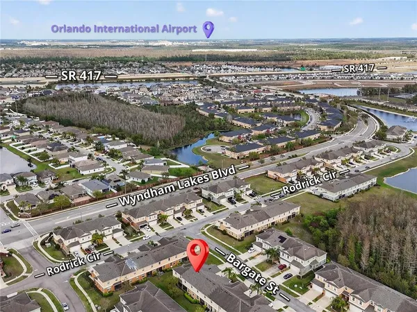 an aerial view of residential houses with outdoor space and city view