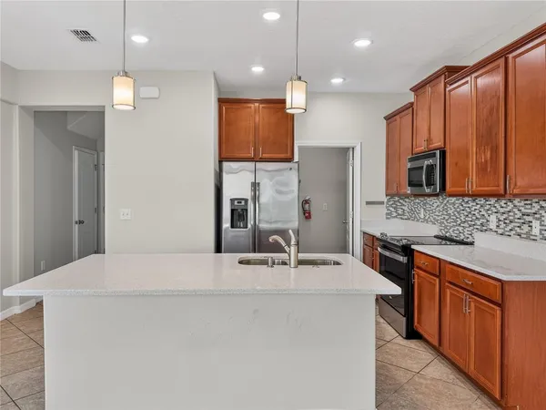 a bathroom with a sink a faucet a mirror and shower