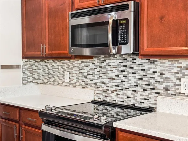 a stove top oven sitting inside of a kitchen