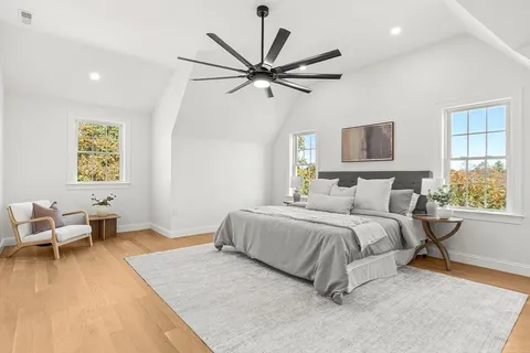 a spacious bedroom with a bed a couch and a window