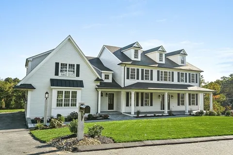 a front view of a residential houses with yard