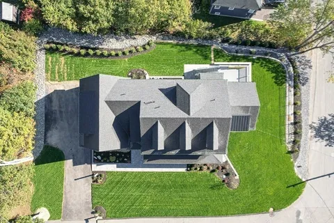 an aerial view of a house with a yard
