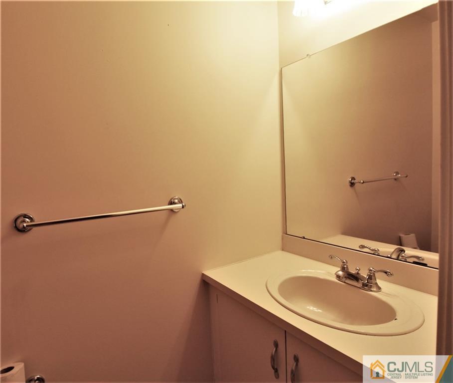 64 Goodwin Drive North Brunswick, NJ 08902 - Photo 13 of 25 a bathroom with a sink and a mirror