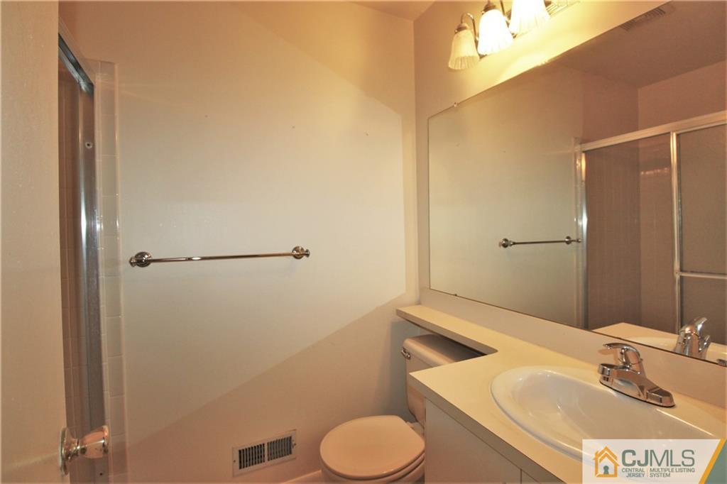 64 Goodwin Drive North Brunswick, NJ 08902 - Photo 17 of 25 a bathroom with a granite countertop sink and a mirror