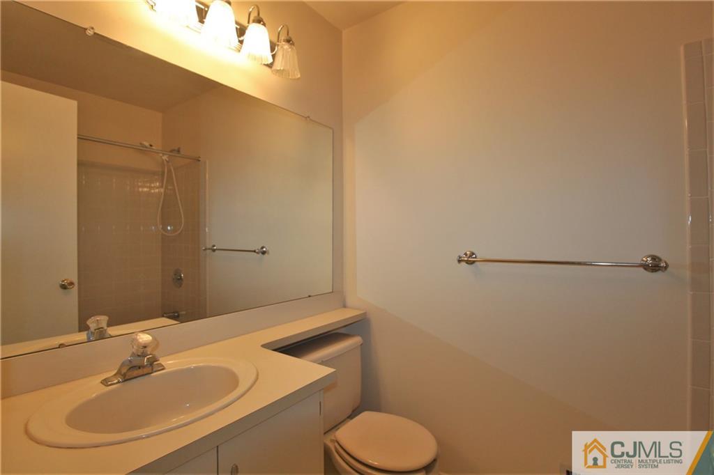 64 Goodwin Drive North Brunswick, NJ 08902 - Photo 22 of 25 a bathroom with a sink toilet and mirror