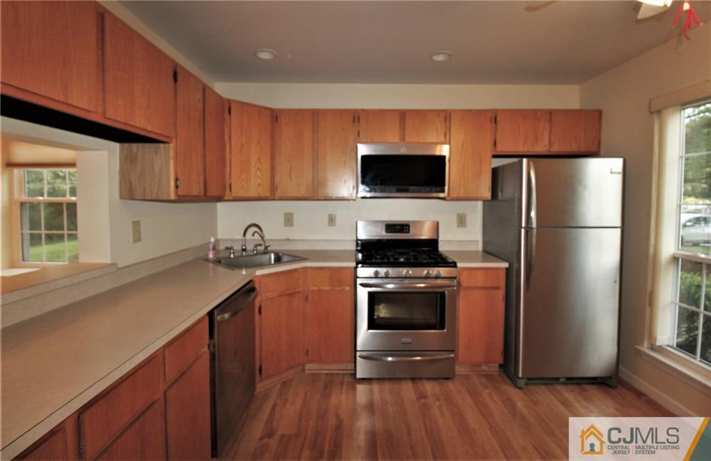 64 Goodwin Drive North Brunswick, NJ 08902 - Photo 4 of 25 a kitchen with a refrigerator stove and microwave