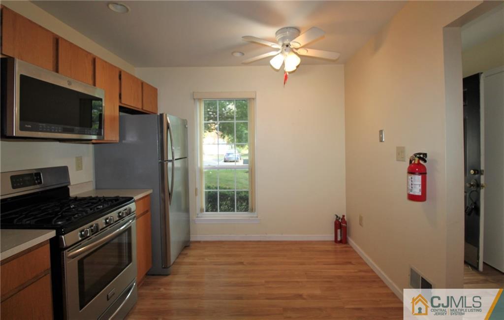 64 Goodwin Drive North Brunswick, NJ 08902 - Photo 6 of 25 a kitchen with granite countertop a stove and a microwave
