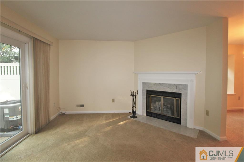 64 Goodwin Drive North Brunswick, NJ 08902 - Photo 10 of 25 a view of an empty room with a window and fireplace