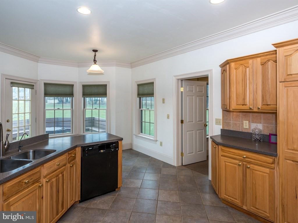 785 Rohen Ridge Drive Lititz, PA 17543 - Photo 16 of 36 a large kitchen with granite countertop a sink and dishwasher a stove with wooden cabinets