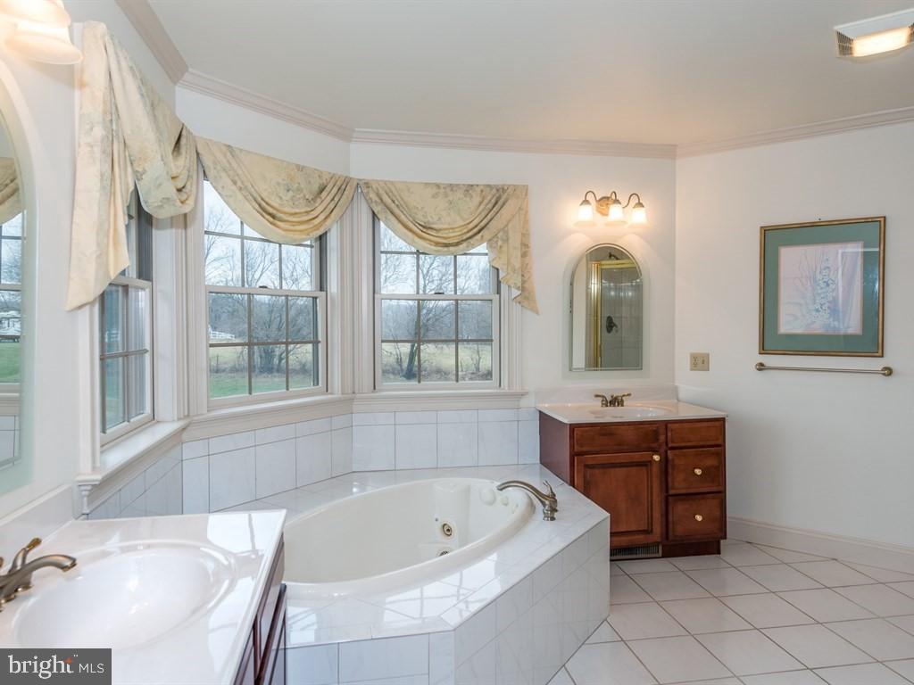 785 Rohen Ridge Drive Lititz, PA 17543 - Photo 22 of 36 a spacious bathroom with a tub sink and mirror