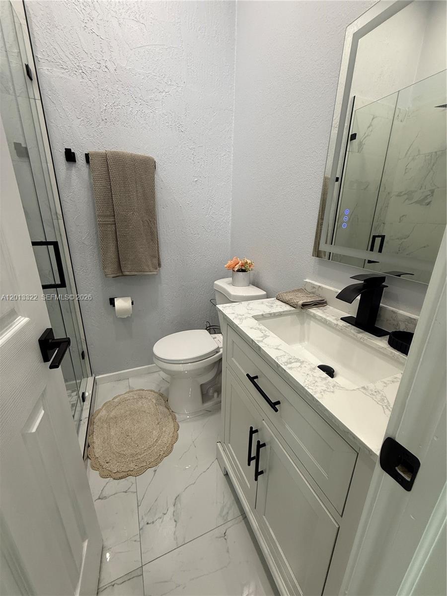13204 Southwest 228th Street, Unit A Miami, FL 33170 - Photo 7 of 8 a bathroom with a sink and a toilet