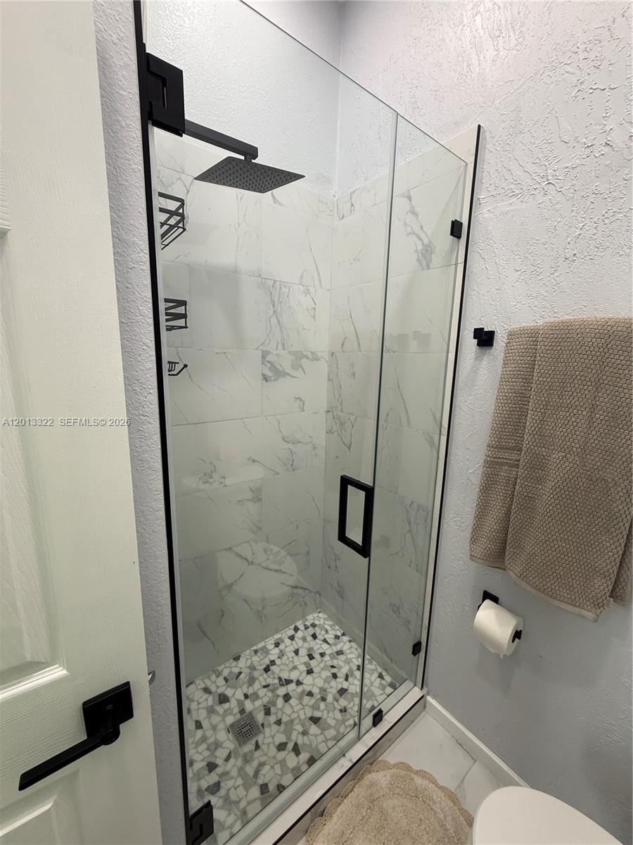 13204 Southwest 228th Street, Unit A Miami, FL 33170 - Photo 8 of 8 a bathroom with a shower and a toilet