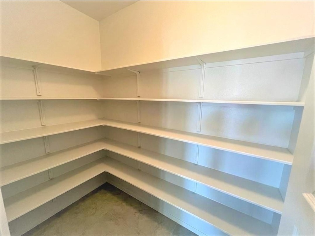 2771 Winding Creek Road Kyle, TX 78640 - Photo 7 of 24 Ample built-in shelving lines this generously proportioned pantry, offering substantial storage.