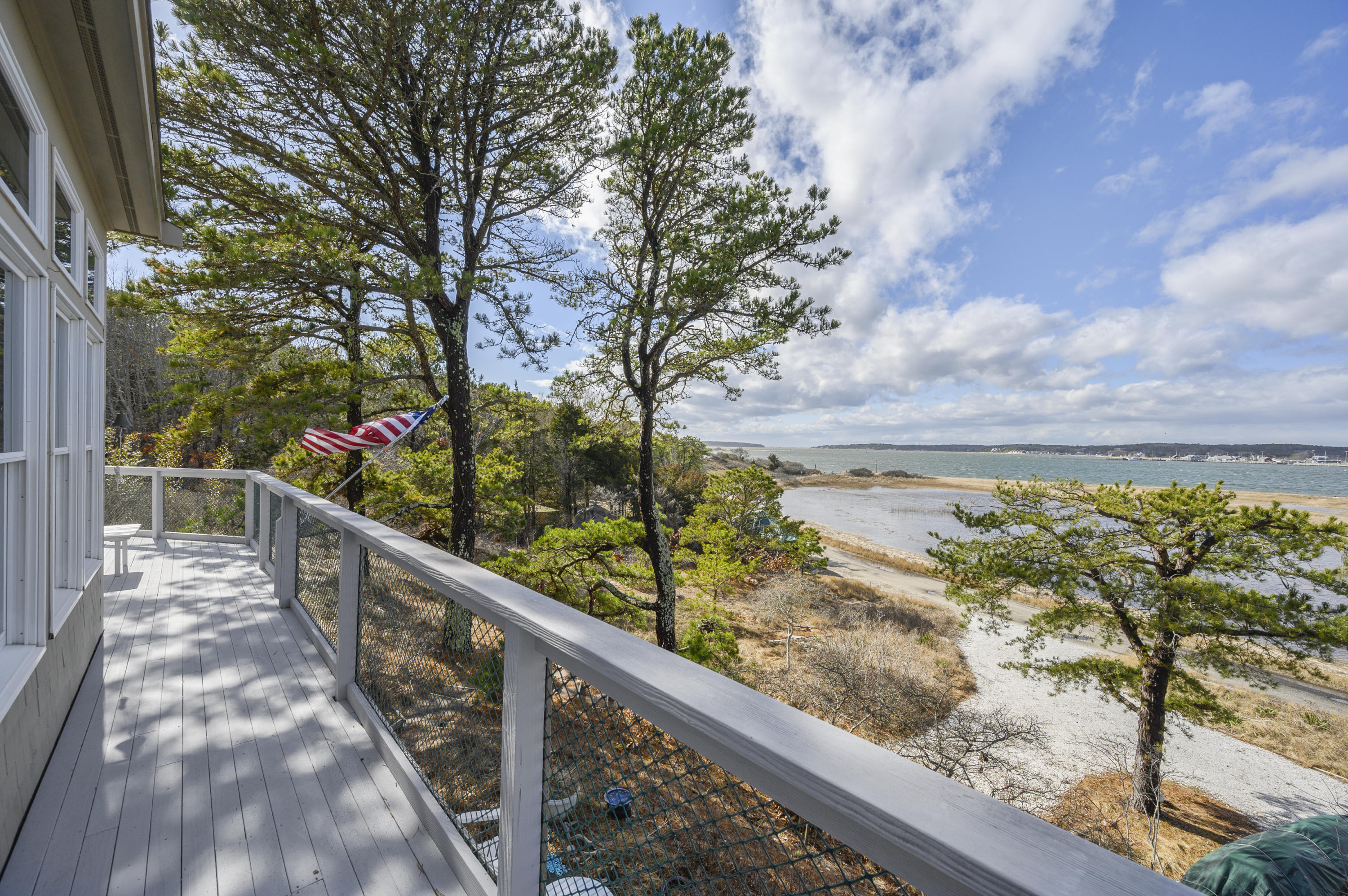 20 Partridge Way Wellfleet, MA 02667 - Photo 7 of 43 a view of a balcony with wooden floor and fence