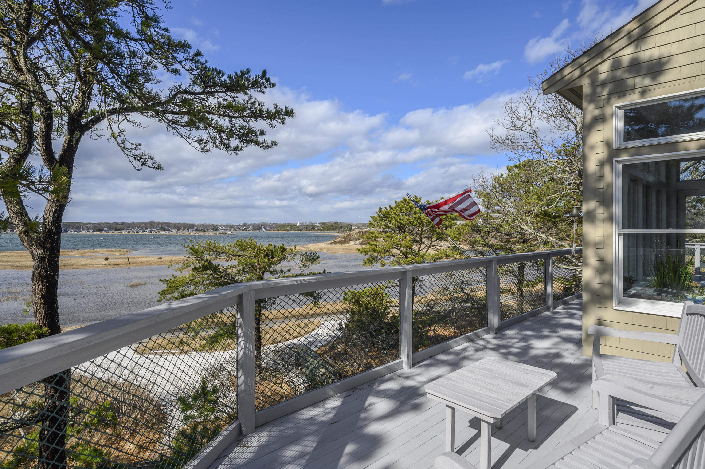 20 Partridge Way Wellfleet, MA 02667 - Photo 9 of 43 a view of a balcony with two chairs and a table