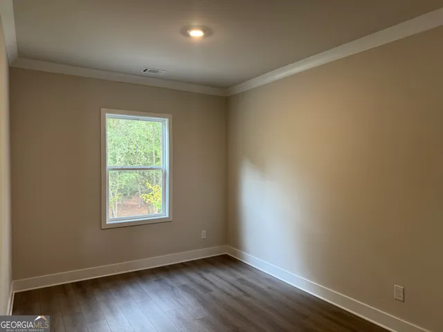 a front view of a house with a garden and plants