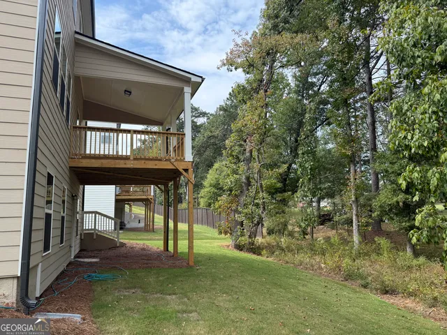 a view of a chairs and table in front of house
