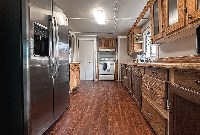 3305 Cherokee Avenue Columbus, GA 31906 - Photo 18 of 50 a kitchen with stainless steel appliances granite countertop a refrigerator and a stove top oven