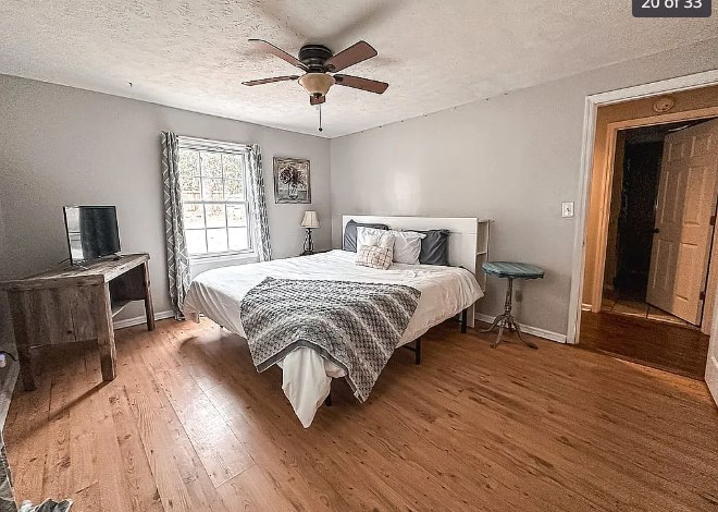3305 Cherokee Avenue Columbus, GA 31906 - Photo 26 of 50 a bedroom with a bed a chandelier and a flat screen tv