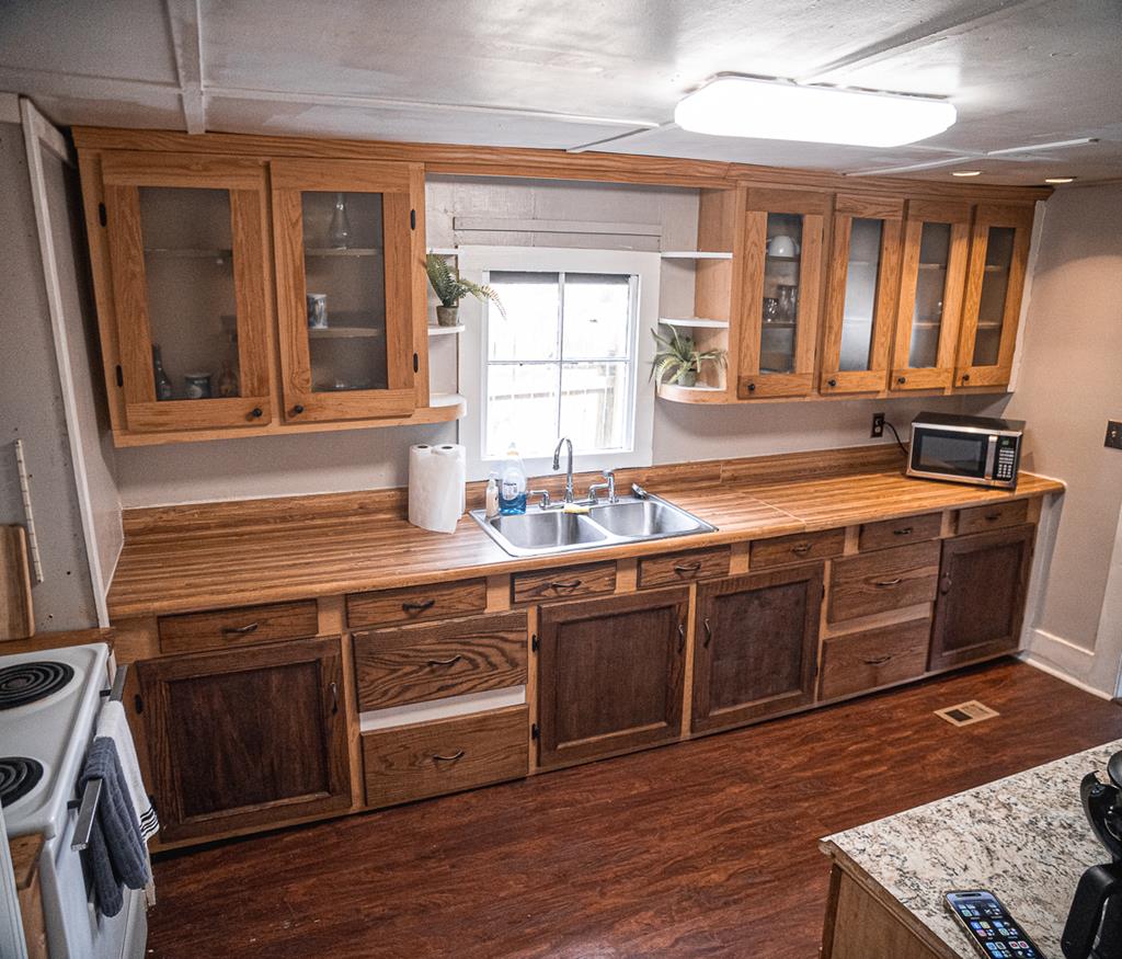 3305 Cherokee Avenue Columbus, GA 31906 - Photo 40 of 50 a kitchen with stainless steel appliances granite countertop a sink stove and wooden floor