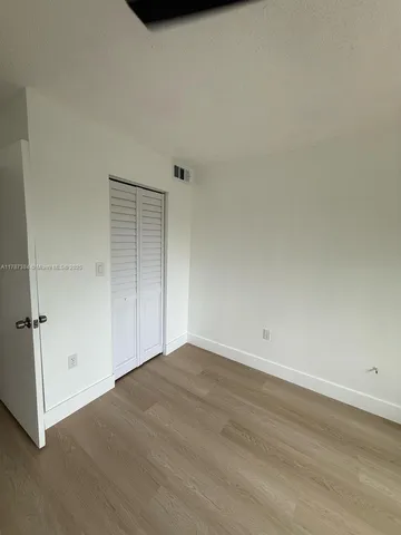 an empty room with wooden floor