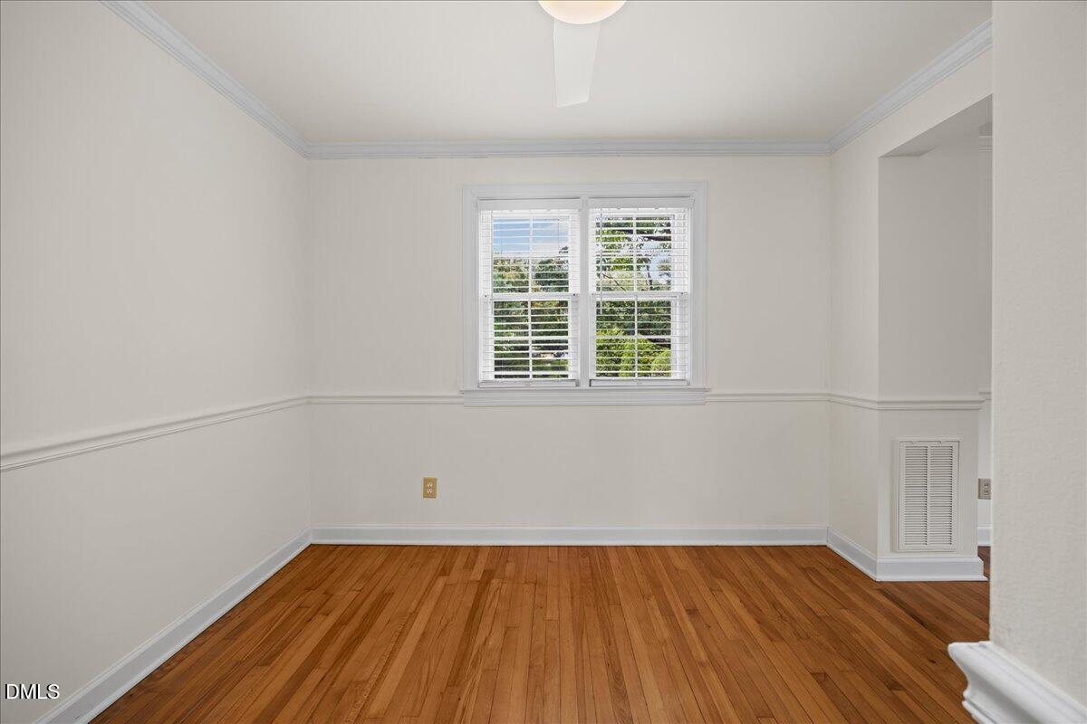 1627 Sutton Drive Raleigh, NC 27605 - Photo 13 of 33 a view of a room with wooden floor and white walls
