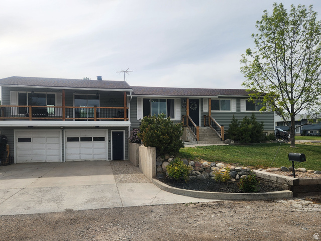 705 North 700 East Payson, UT 84651 - Photo 1 of 30 View of front of property with concrete driveway, an attached garage, a front lawn, a balcony, and a shingled roof