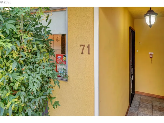 a living room with furniture a fireplace and a large mirror
