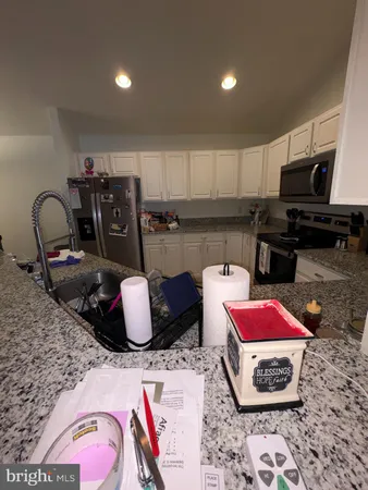 a kitchen with a microwave a stove and cabinets