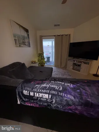 a living room with a couch a rug and a flat screen tv