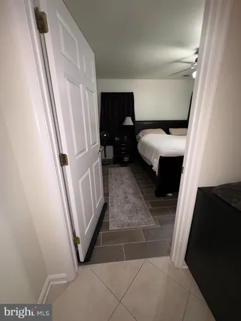 a bedroom with a bed and a mirror