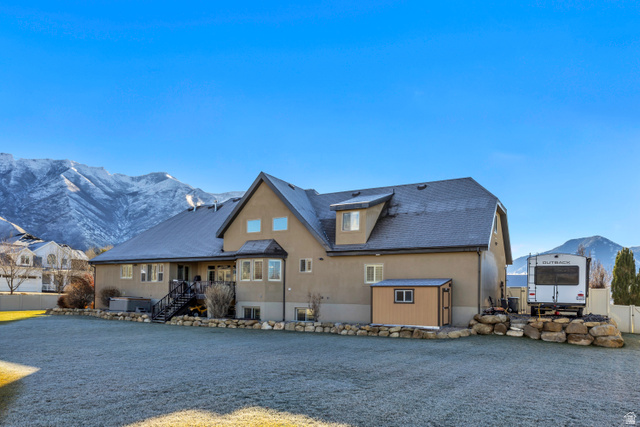 896 West 675 South Mapleton, UT 84664 - Photo 61 of 77 Back of house with a mountain view, a storage unit, stairway, and stucco siding