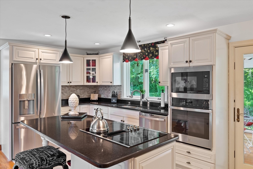 58 Rice Corner Road Brookfield, MA 01506 - Photo 11 of 41 a kitchen with kitchen island granite countertop a sink stainless steel appliances and cabinets