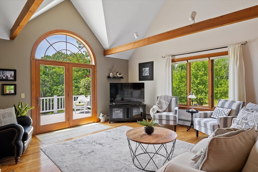 58 Rice Corner Road Brookfield, MA 01506 - Photo 14 of 41 a living room with furniture a fireplace and a floor to ceiling window